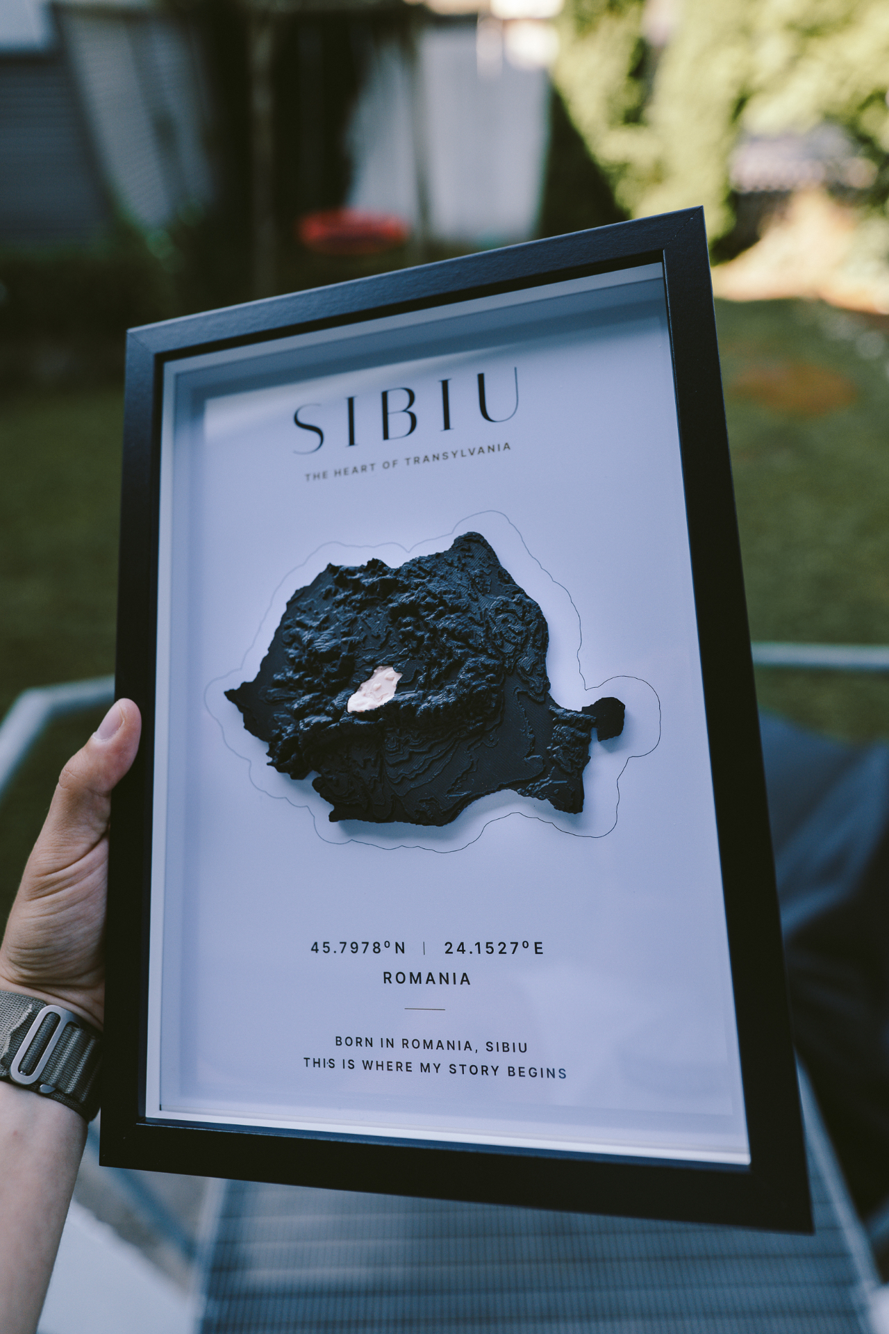 VUMO Sibiu A4 framed piece held outdoors in daylight