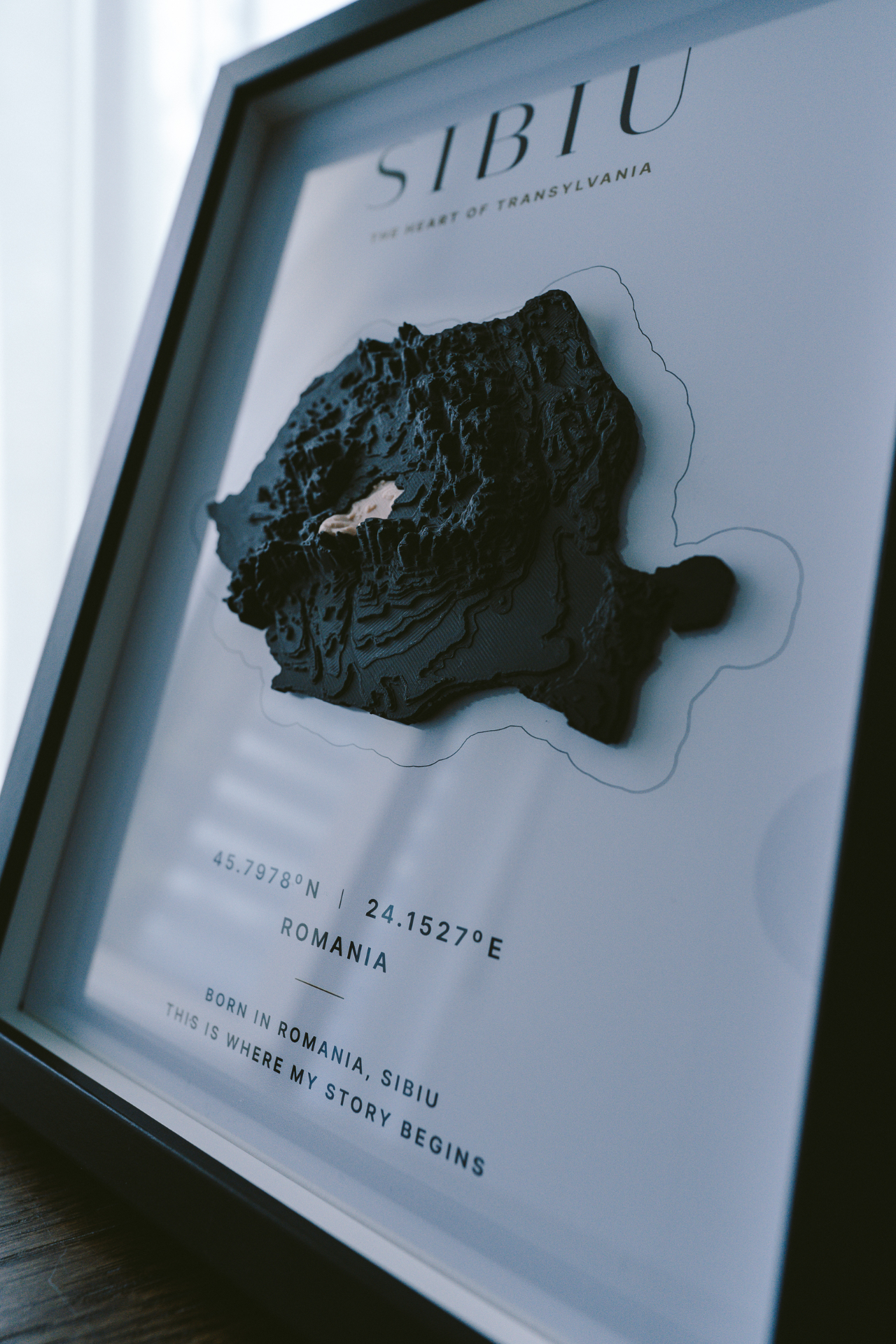 VUMO Sibiu A4 framed piece — angled detail by window light
